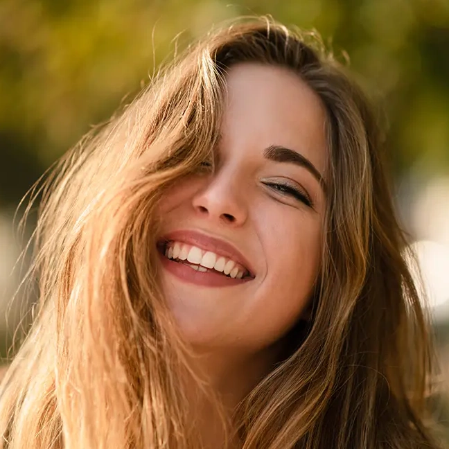 Woman smiling after smile design treatment