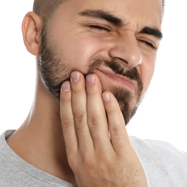 Man holding jaw due to TMJ discomfort